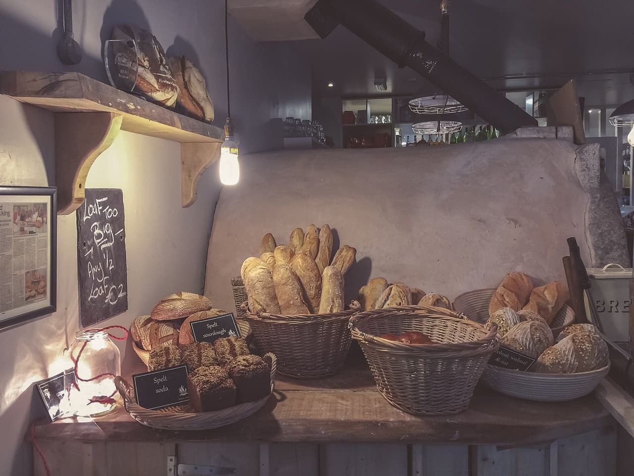 Rustic bread loaves in baskets on a bakery counter